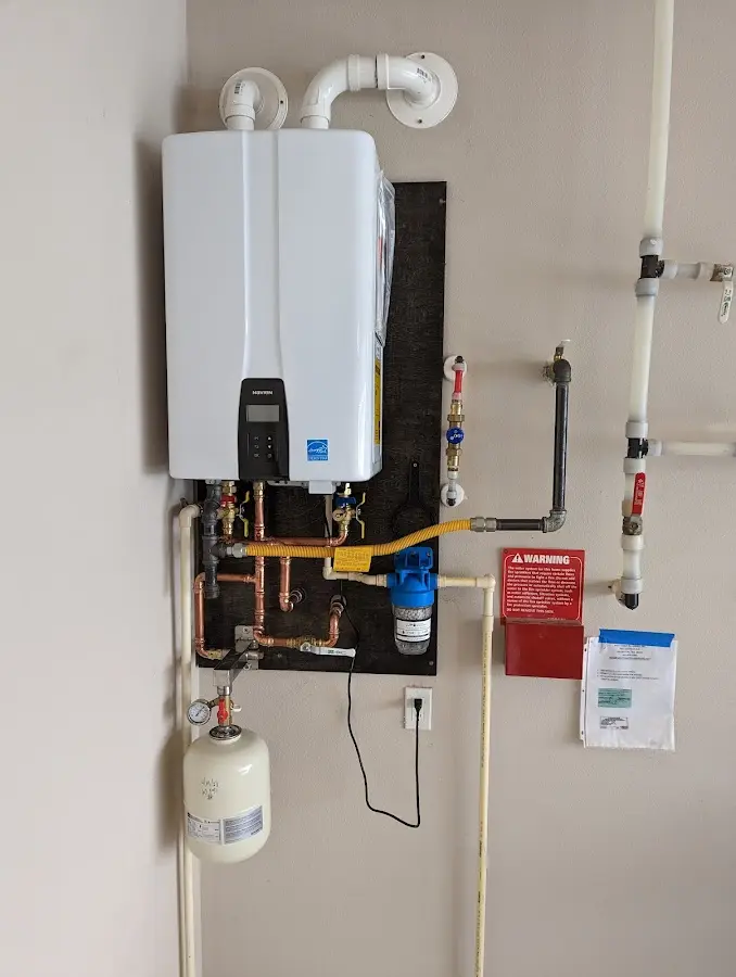 Professional plumber installing copper piping in a Greenville home